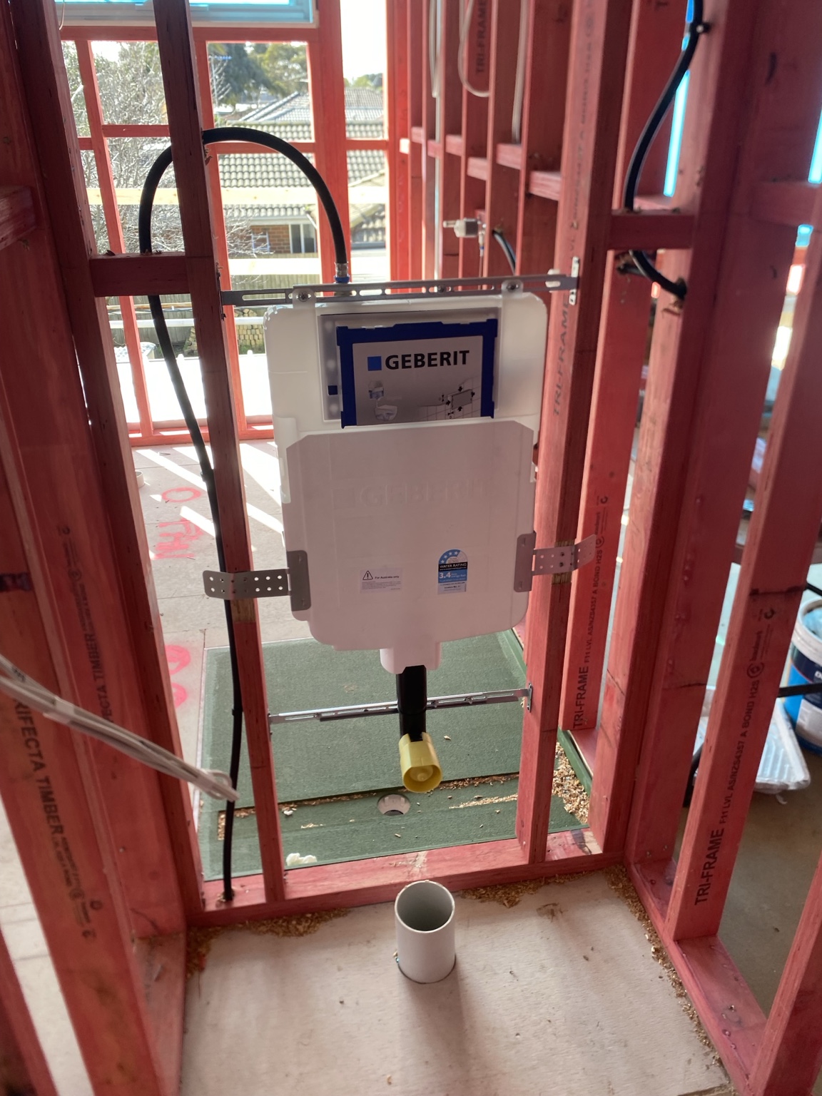 Concealed in-wall cistern and bathroom rough-in plumbing during construction